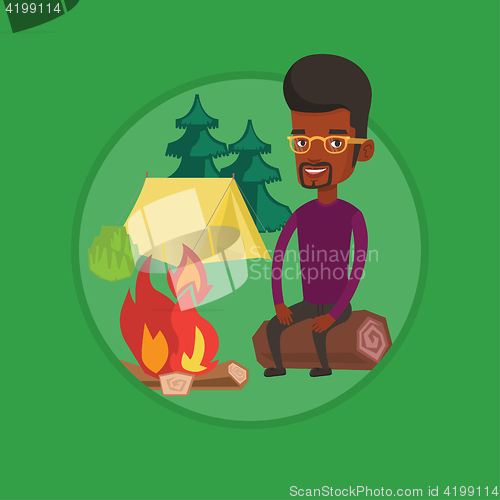Image of Man sitting on log near campfire in the camping.