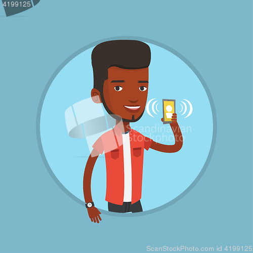 Image of Man holding ringing mobile phone.