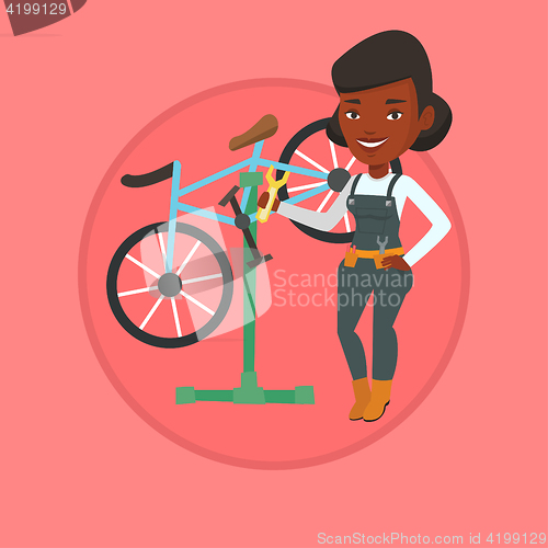 Image of African bicycle mechanic working in repair shop.