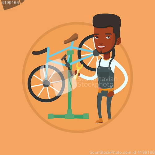 Image of African bicycle mechanic working in repair shop.