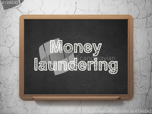 Image of Currency concept: Money Laundering on chalkboard background