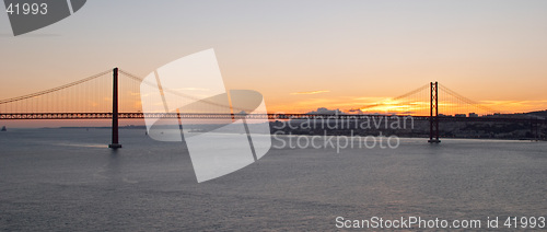 Image of Bridge 25 de Abril on river Tagus at sunset, Lisbon, Portugal