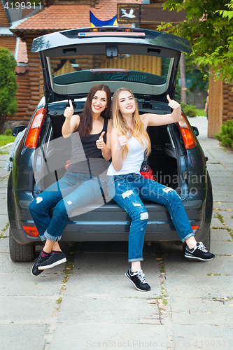 Image of Two girls posing in car