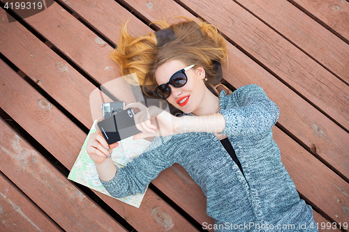 Image of Woman with cellphone taking photo