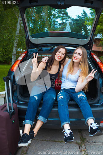 Image of Two girls posing in car