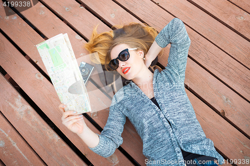 Image of Young woman with map