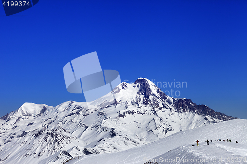 Image of Off-piste slope and mount Kazbek at sun winter day