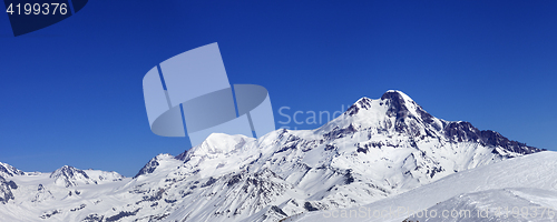 Image of Panoramic view on off-piste slope and mount Kazbek at sun winter