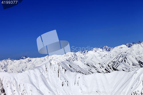 Image of Winter snow mountains and blue clear sky