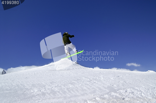 Image of Snowboarder jump in snow park at ski resort on sun winter day