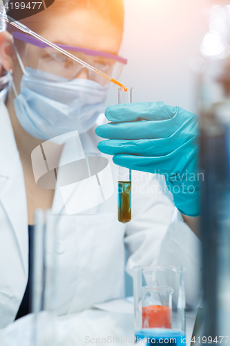 Image of Lab assistant handling chemical agents