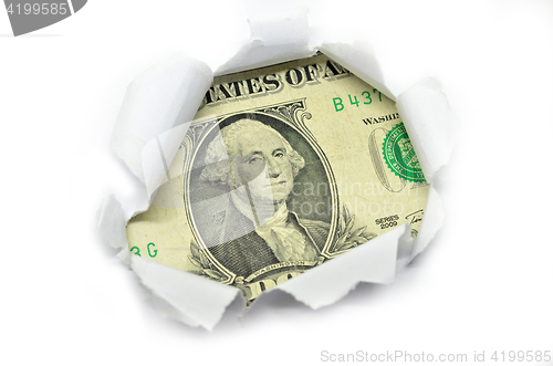 Image of US currency peeking through white paper.