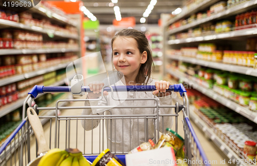 Image of girl with food in shopping cart at grocery store