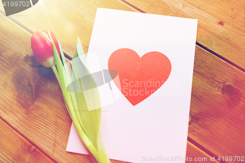 Image of close up of flowers and greeting card with heart