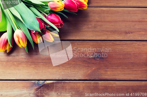 Image of close up of tulip flowers on wooden table