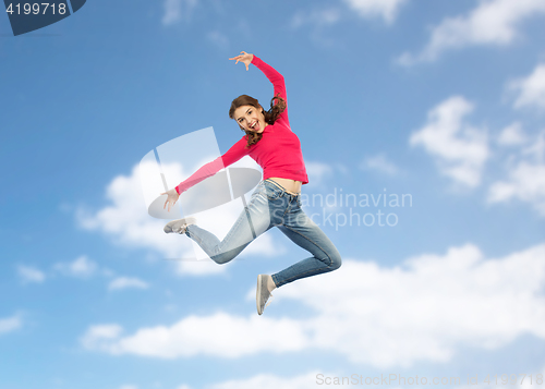 Image of happy young woman jumping in air or dancing