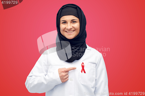 Image of muslim doctor in hijab with red awareness ribbon