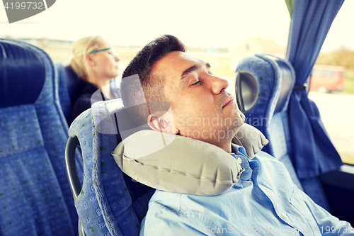 Image of man sleeping in travel bus with cervical pillow