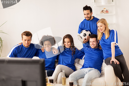 Image of friends or football fans watching soccer at home
