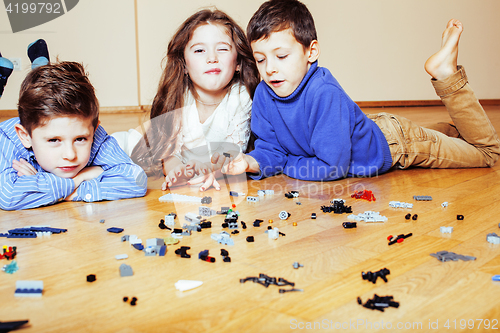 Image of funny cute children playing lego at home, boys and girl smiling, first education role lifestyle