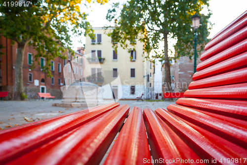 Image of Venice from a red bench