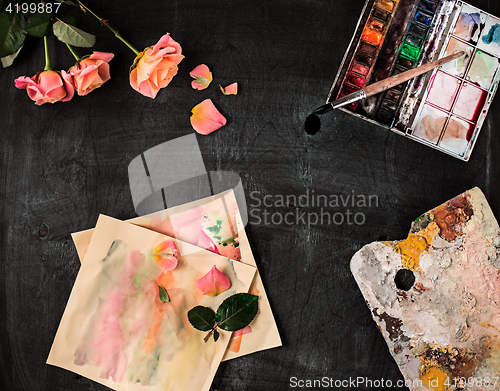 Image of paint brushes and tubes of oil paints on wooden background