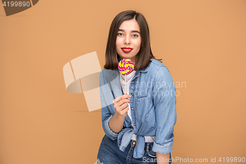 Image of The young woman with colorful lollipop