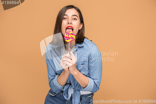 Image of The young woman with colorful lollipop