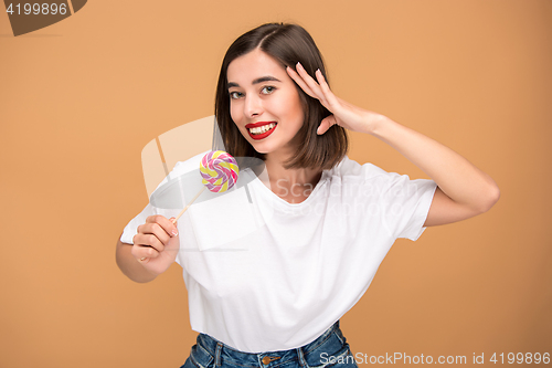 Image of The young woman with colorful lollipop