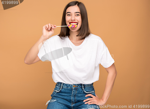 Image of The young woman with colorful lollipop