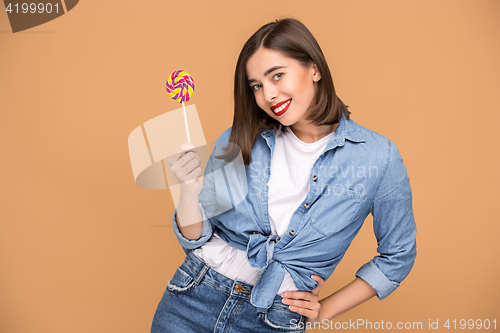 Image of The young woman with colorful lollipop