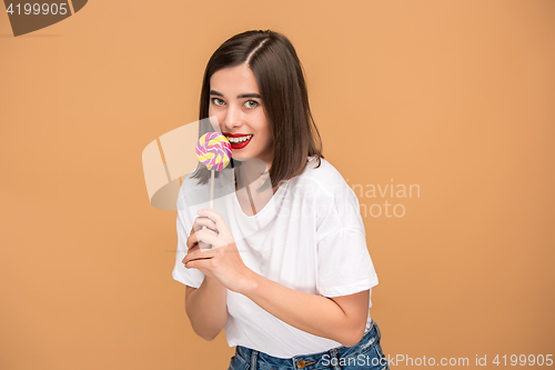 Image of The young woman with colorful lollipop