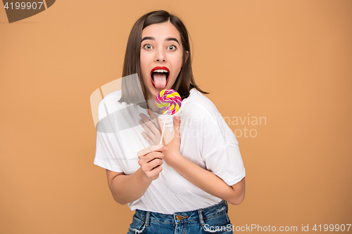 Image of The young woman with colorful lollipop