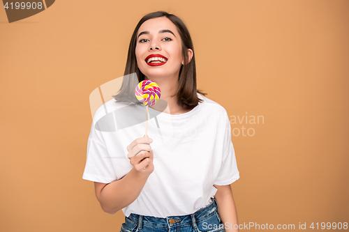 Image of The young woman with colorful lollipop