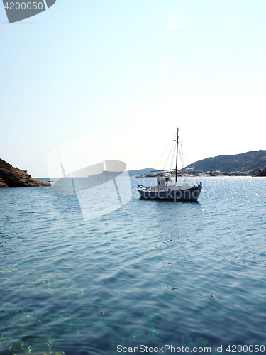 Image of old wood sailboat in Mediterranean Sea Faros harbor on Greek Isl