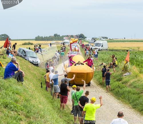 Image of St. Michel Madeleines Caravan on a Cobblestone Road- Tour de Fra