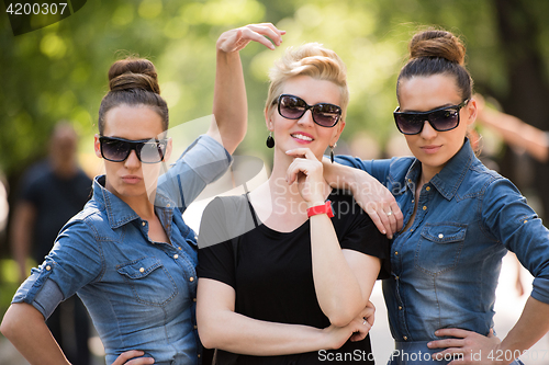 Image of portrait of three young beautiful woman with sunglasses