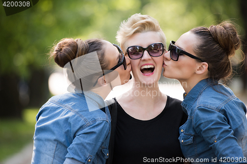 Image of portrait of three young beautiful woman with sunglasses