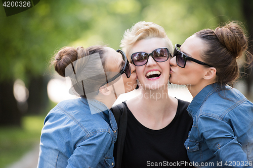 Image of portrait of three young beautiful woman with sunglasses