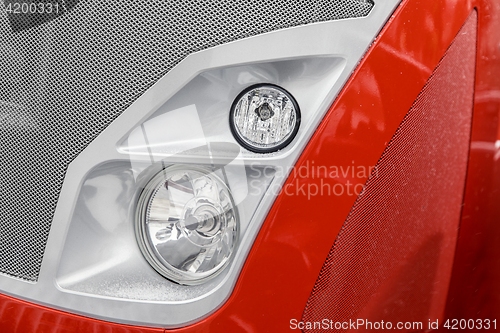 Image of Headlight of a red car