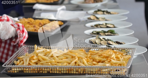 Image of French fries and meat on the table