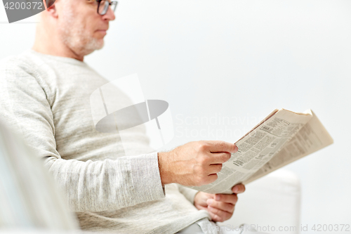 Image of close up of senior man reading newspaper