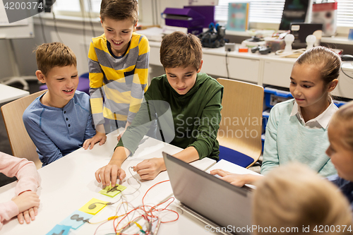 Image of kids, laptop and invention kit at robotics school