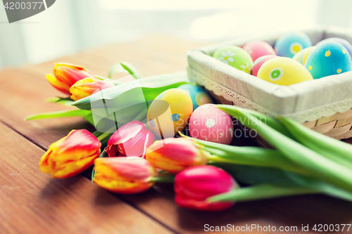 Image of close up of colored easter eggs and flowers