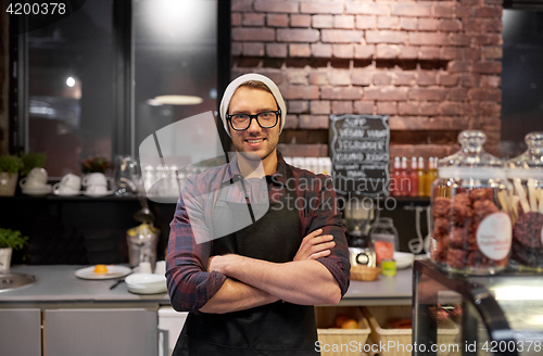 Image of happy seller man or barman at cafe counter