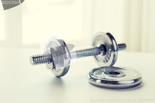 Image of close up of iron dumbbell on table