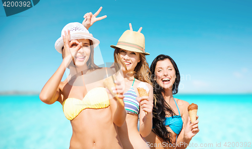 Image of happy women eating ice cream over sea and sky