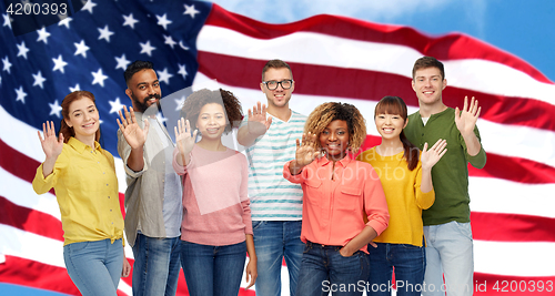 Image of international people waving hand and american flag