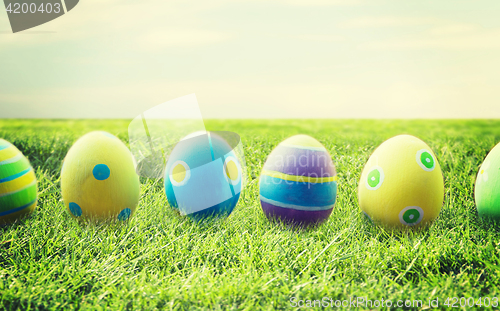 Image of close up of colored easter eggs on wooden surface