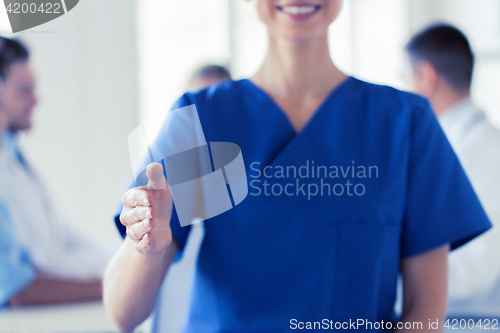 Image of close up of doctor reaching out hand at hospital